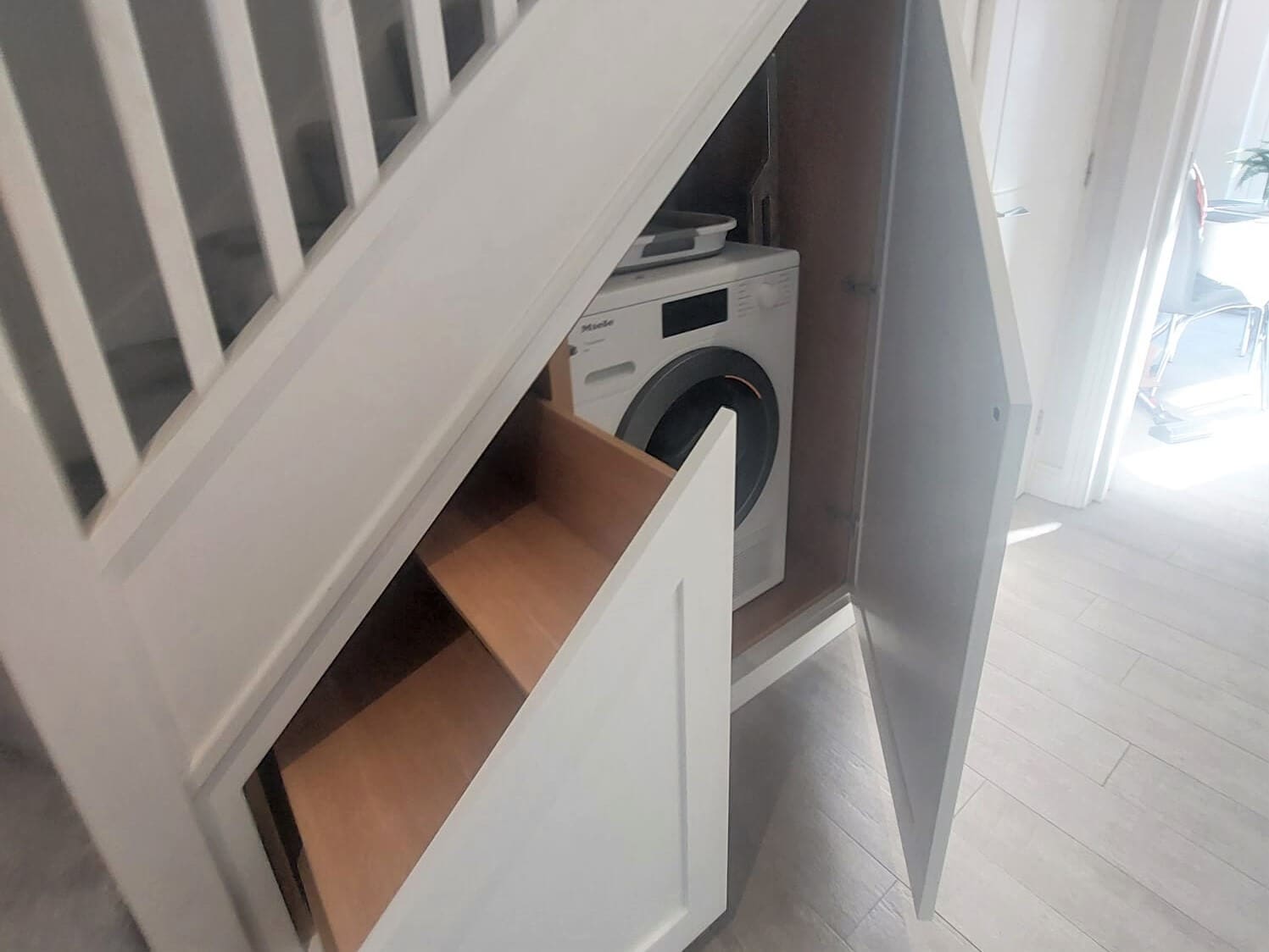 Under Stairs Storage with washing machine bay and shoe racks